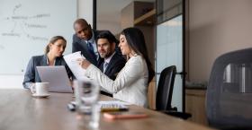 group of employees looking over papers